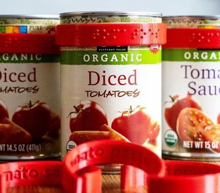Plastic jar labels wrapped around tins