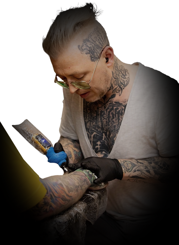 Tattooist working on a man's arm