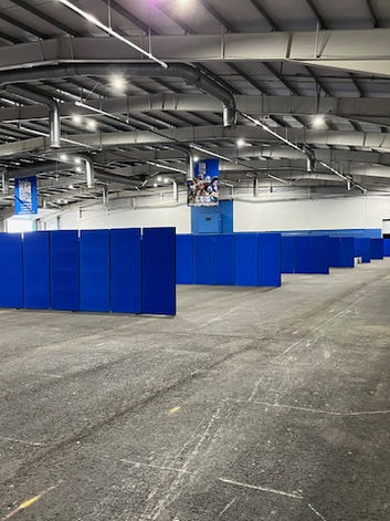 exhibition hall full of blue poster boards