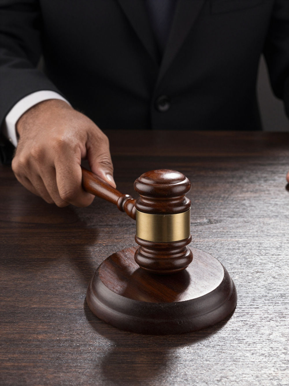 Hand holding gavel, addressing civil rights violations