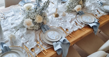 pale dusky blue table styling setting gold  cutlery gold glass charger plate and fresh blue centerpiece for a 1st wonderland birthday dinner party party ideas in London Surrey Kent Essex 
