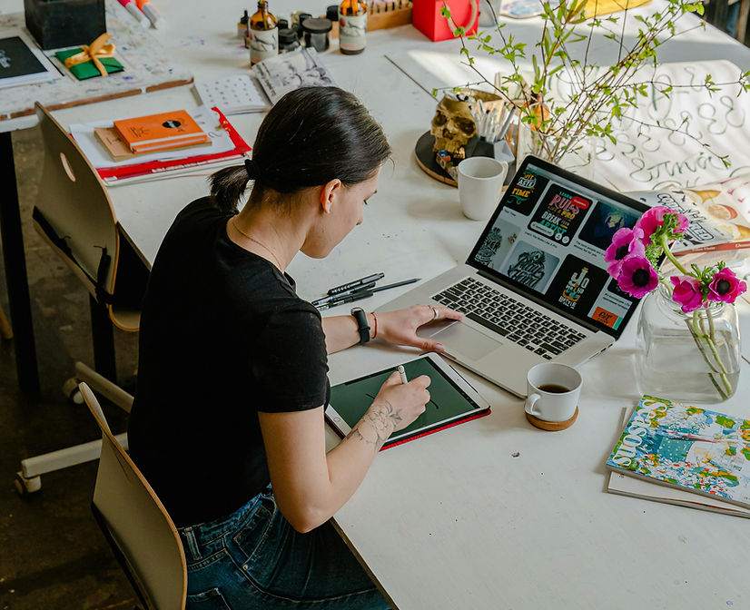 Person working with laptop and drawing tablet