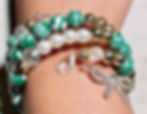 Green patterned wrap bracelet with pearl accents, rhinestone bow detail, and crystal elements in a playful statement design.