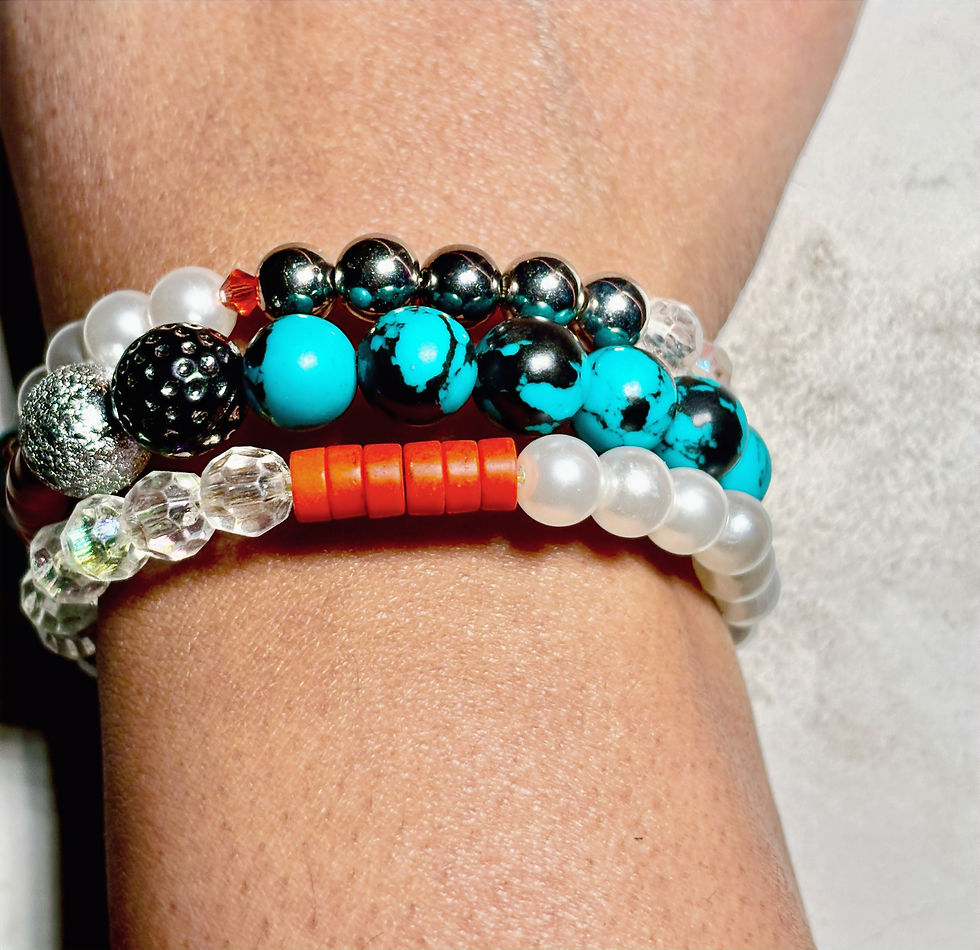 Multi-layer wrap bracelet with turquoise beads, pearl accents, crystal details, and bold orange contrast elements.