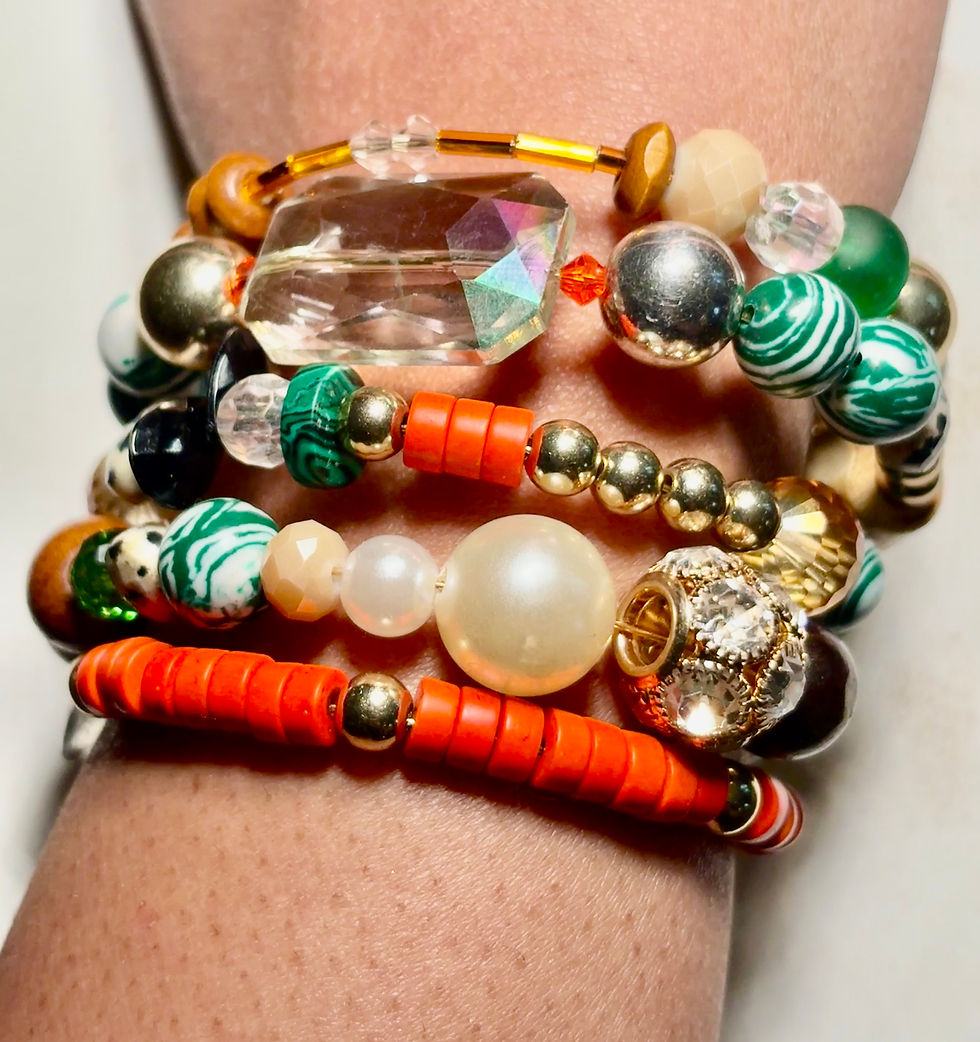 Layered wrap bracelet with vibrant beads, pearl accents, crystals, and mixed textures in an expressive statement design.