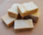 Cubes of caramel fudge with salt on kraft paper.