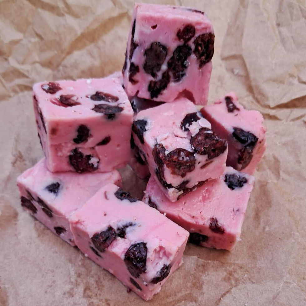 Cubes of cranberry fudge on kraft paper.