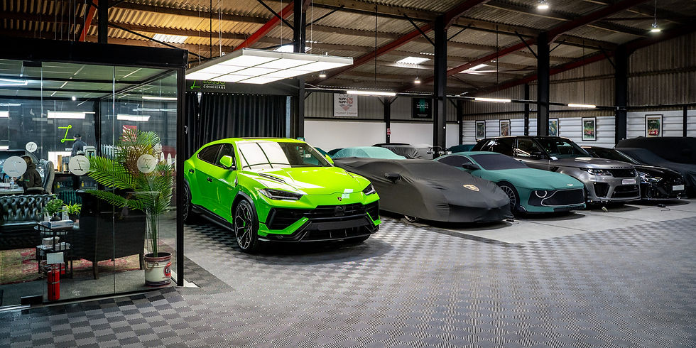A Lamborghini urus performante at a supercar storage facility - Lusso Concierge - in Leeds sat on a handover bay after receiving paint protection film. surrounded by supercars