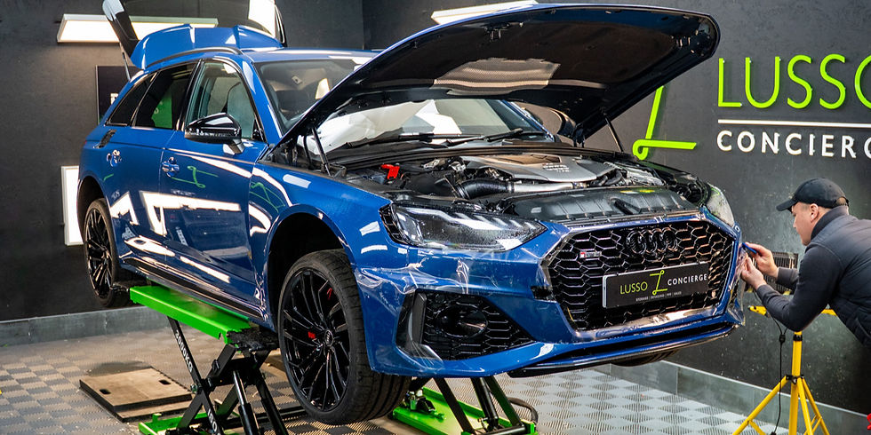 An Audi RS4 B9 on a scissor lift at Lusso Concierge in Leeds, in their PPF bay receiving paint protection film