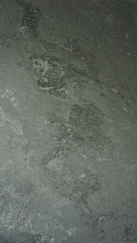 Close up of concrete wall panel with natural stone aesthetic, the wall panel has a warm neutral color palette of warm greys and off whites.