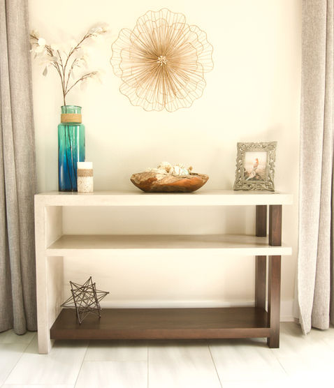 Console table made of warm grey concrete and ebony stained poplar wood with a rustic, coastal vibe.