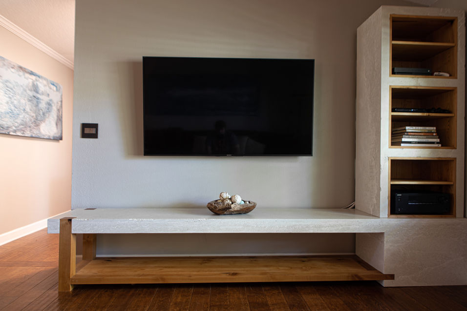 White concrete and alder wood entertainment center with large unsupported span, half lap joinery, and wood cubbies with adjustable shelves for electronic devices.