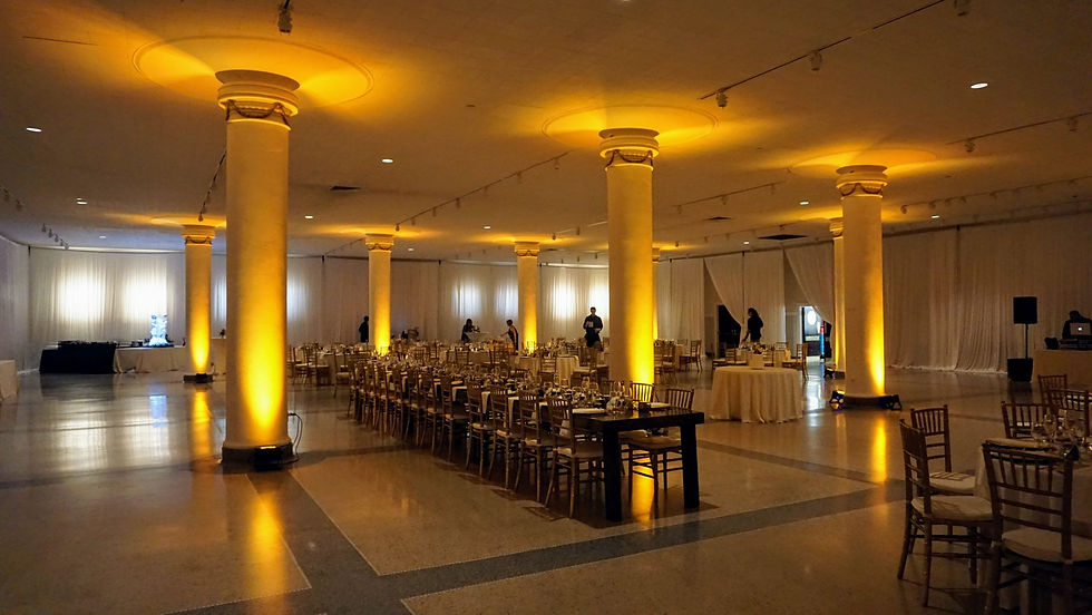 Indoor Wedding Reception with Gold Uplighting