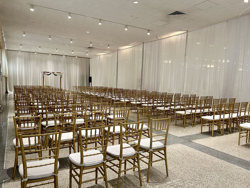 Indoor Wedding Reception with White Silk Pleated Wall Draping and Gold Chiavaris