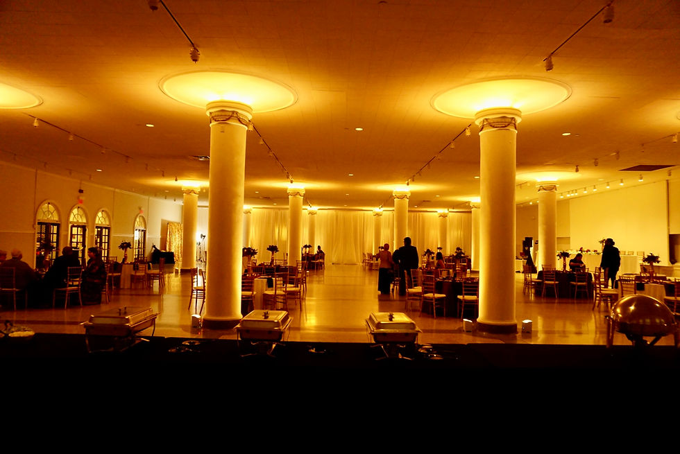 Indoor Wedding Reception with Gold Uplighting