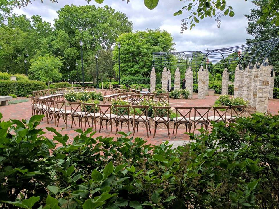 Outdoor Wedding Reception with Chairs in Semi-Circle Around Alter