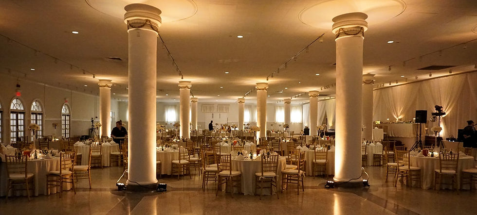 Indoor Wedding Reception with Warm Toned Off White Uplighting