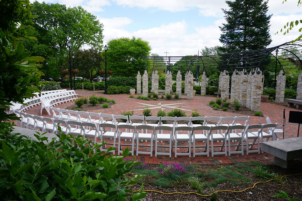 Outdoor Wedding Ceremony with White Folding Chairs Arranged in a Semi-Circle