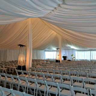 Illuminating Tent Lighting for tent wedding ceremony with outdoor heaters and folding chairs 