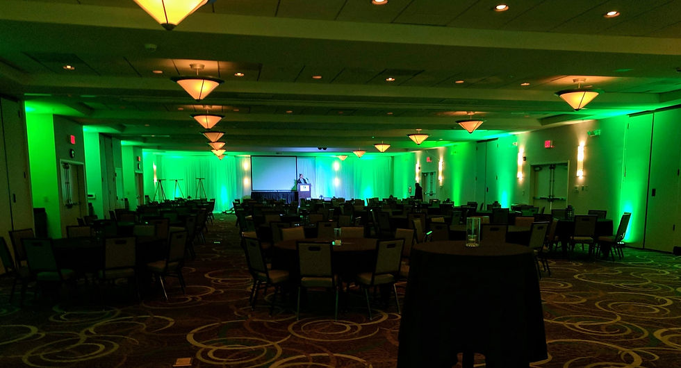 Indoor Event with Green Uplighting Around The Perimeter of The Room