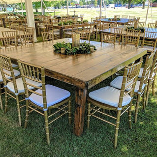 outdoor pole tent wedding reception with 6ft X 6ft Rectangle Dark Roast Wood Harvest Table with gold chiavari chairs with cushions 