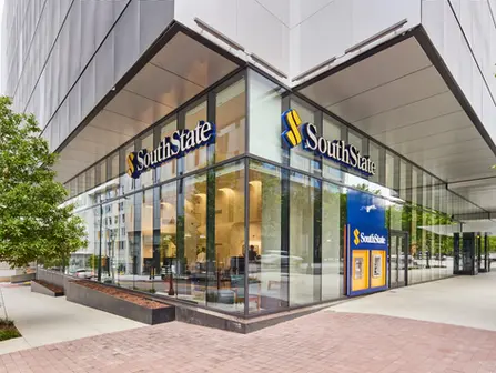 Glass exterior of SouthState Bank branch with modern facade and visible ATM, captured in commercial architectural photography.