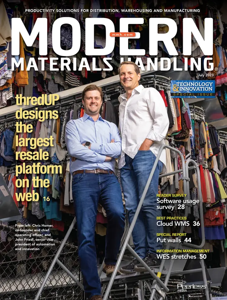 A business portrait of two company founders standing on a staircase in a warehouse, featured on a trade magazine cover.