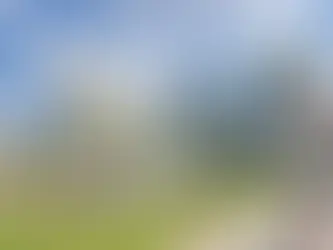 Large white abstract sculpture in front of modern modular building