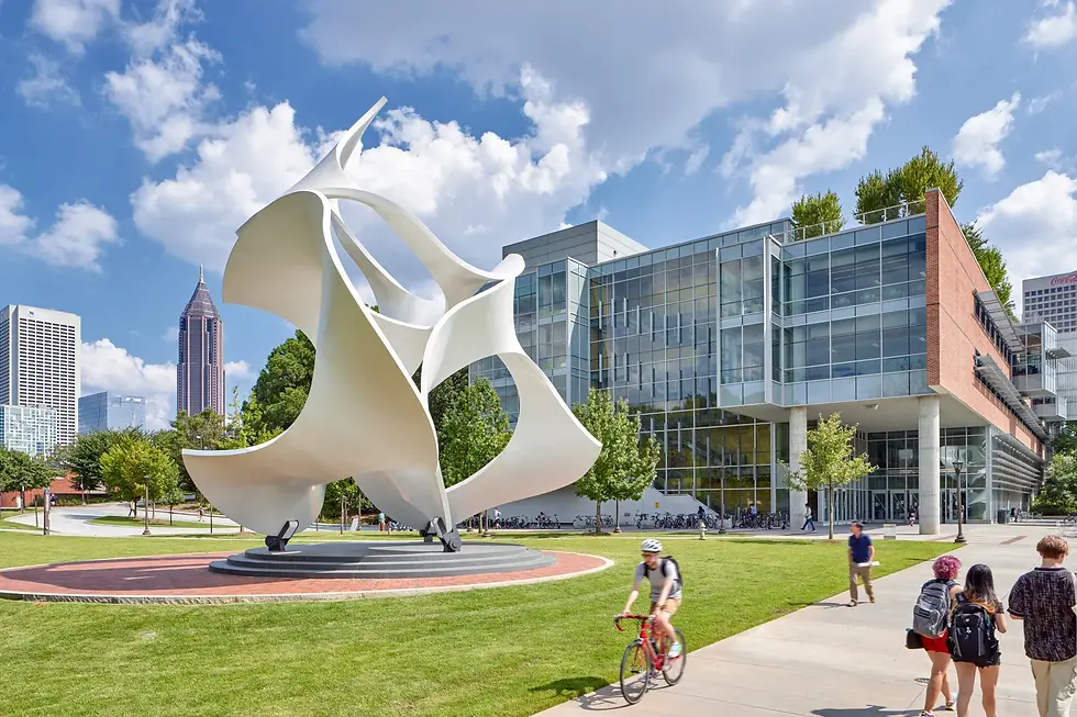 Large white abstract sculpture in front of modern modular building