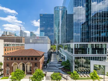 Wide angle photograph of large glass paneled buildings and surrounding exterior architecture