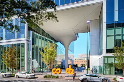 CODA building entrance with cantilevered canopy and column, showcasing futuristic commercial architectural design.
