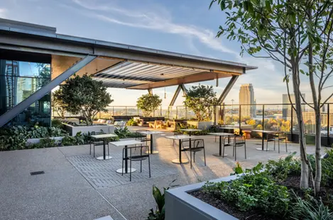 Covered rooftop patio at Anthem Midtown with modern seating and skyline views, captured in commercial architectural photography.