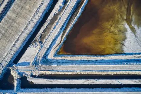 High resolution aerial photography of geometric retention ponds at an industrial site.