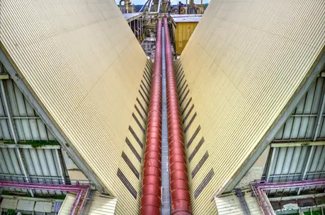 Aerial photography with drones capturing V-shaped rooftops and red industrial pipelines.
