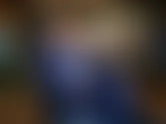 Businessman is blue suit sitting on a chair.