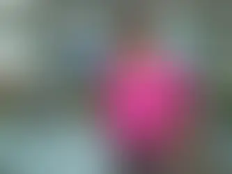 A professional business portrait of a smiling woman standing confidently outside a glass conference room.