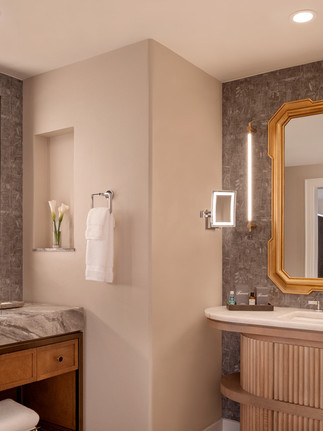 ultra luxurious and spacious bathrooms with gold trim and stone countertops at Fairmont Scottsdale