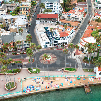aerial view of a round about and palm trees in Catalina next to the beach and water