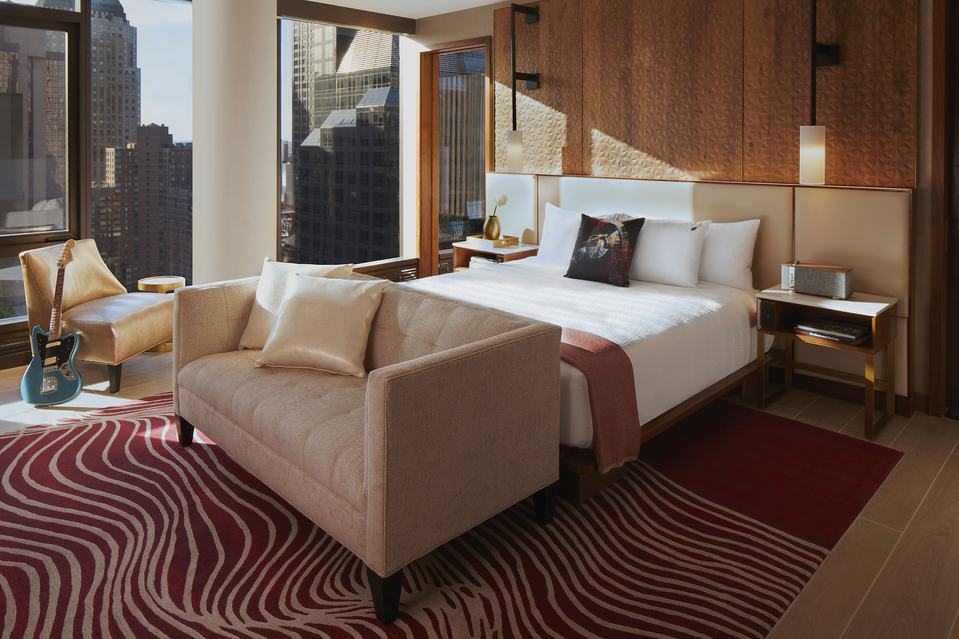 Penthouse Suite Bedroom at the Hard Rock Hotel New York with red carpet, guitar, couches and large bed