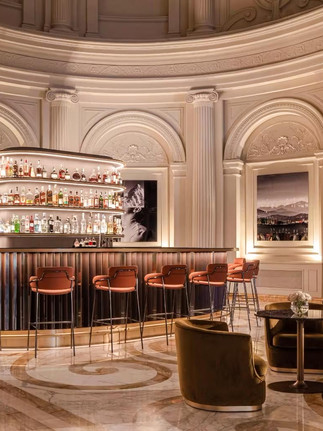 the lobby bar with classical roman architecture and modern furnishings at the Anantara Palazzo Naiadi Rome Hotel