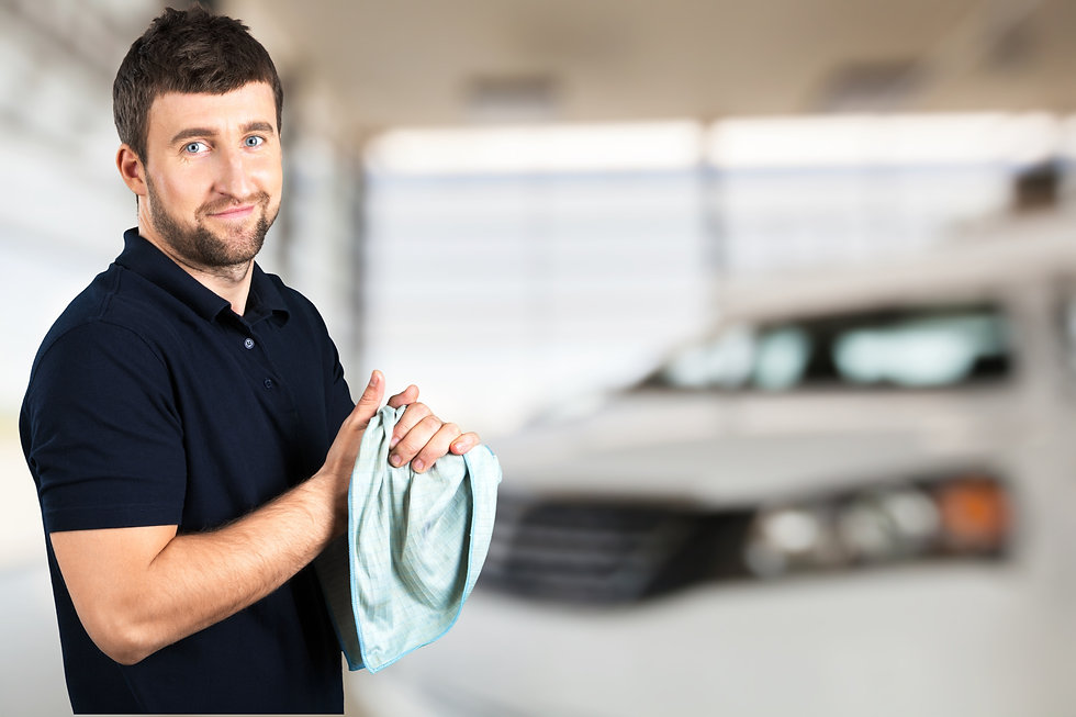 An automotive repair shop owner smiling because he is happy about his shop finanicals being in order using DriveYourKPI's program.