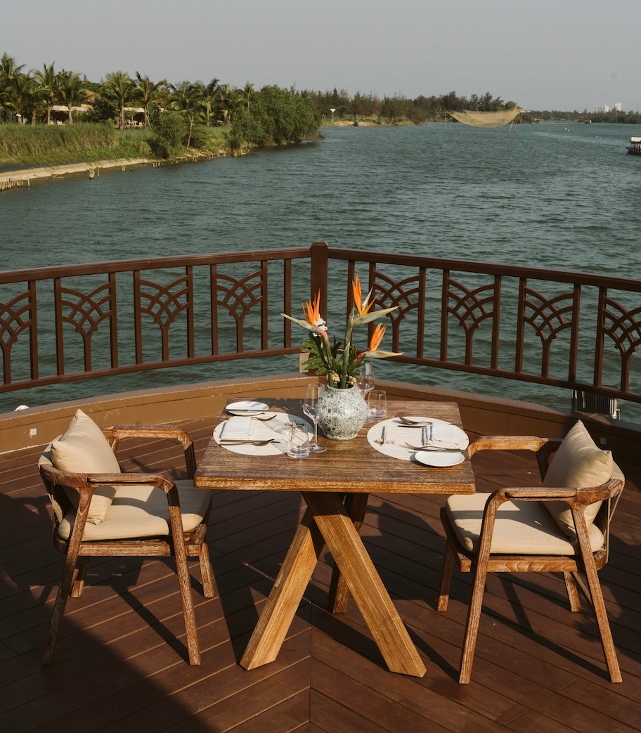 The Merchant River Cruise's outdoor dining area, showcasing luxury cruising experiences in Hoi An, Vietnam.