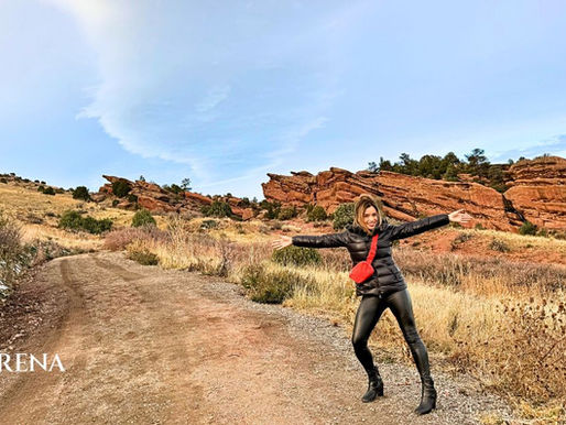 Daniela Udoff standing open-armed at Red Rocks, symbolizing resilience and continuation.