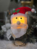 Light-up Santa tree topper with glowing warm face and red hat