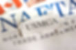 USMCA clipping on top of the NAFTAUSMCA document overlaying NAFTA page - A symbol of the new trade agreement replacing the old.