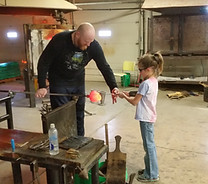 Kid taking a glassblowing class
