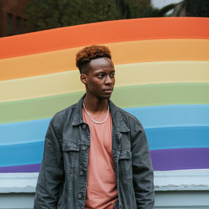 Man in front of pride flag