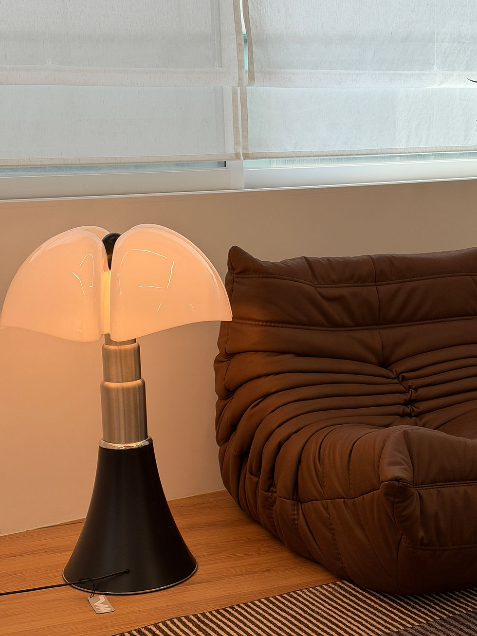 Lamp-lit waiting area with leather sofa at Aya Seoul permanent makeup studio in Gangnam