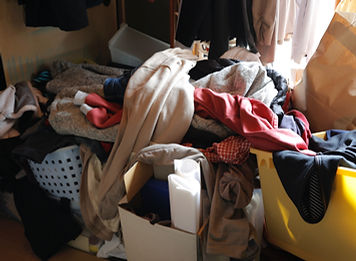 A room piled high with clothes.