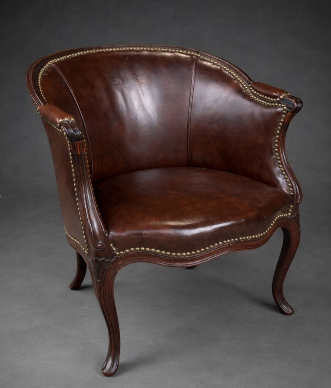 An English George III leather upholstered mahogany tub chair